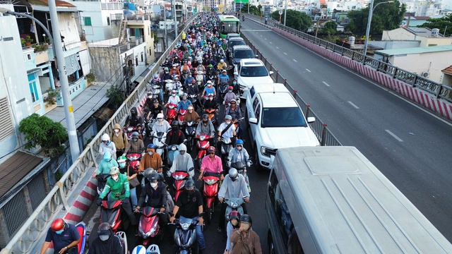 Dòng xe ken đặc trên cầu Kênh Tẻ sau tai nạn giữa xe đầu kéo và xe rác khiến tài xế tử vong - Ảnh 1.