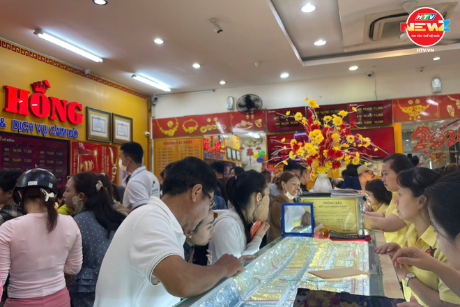 Người dân TP. Hồ Chí Minh đội mưa mua vàng ngày vía Thần Tài - Ảnh 1.