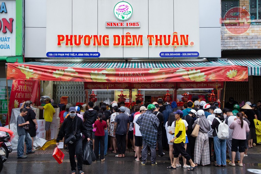 Tiệm tăng giá bánh trung thu, khách vẫn đội mưa chờ đến lượt - Ảnh 2.