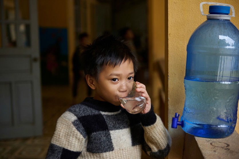 Một học sinh đang uống nước lấy từ hệ thống Gravity Water tại Trường Phổ Thông Dân Tộc Bán Trú Tiểu Học và Trung Học Cơ Sở Vầy Nưa. 