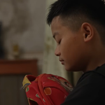 Em Đức Thiện ôm chặt chiếc cặp cũ để nguôi nỗi nhớ mẹ